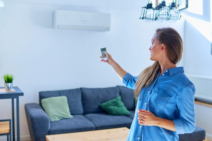 Photo of girl with air conditioning illustrates blog "When was Air Conditioning Invented?"