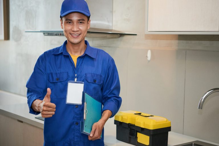 Photo of smiling AC technician illustrates blog: "When Should I Schedule AC Tune-Ups in 2022?"