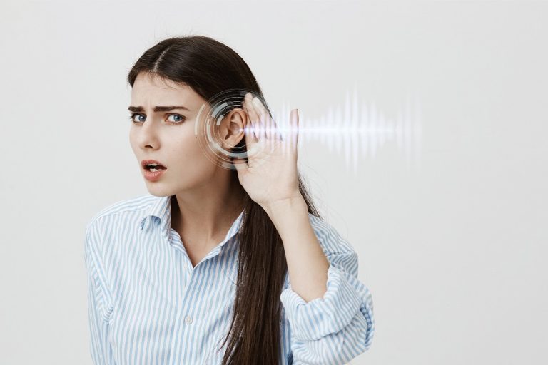 Photo of woman holding hand to her ear with sound waves illustrates blog "Why Is My HVAC Whistling?"