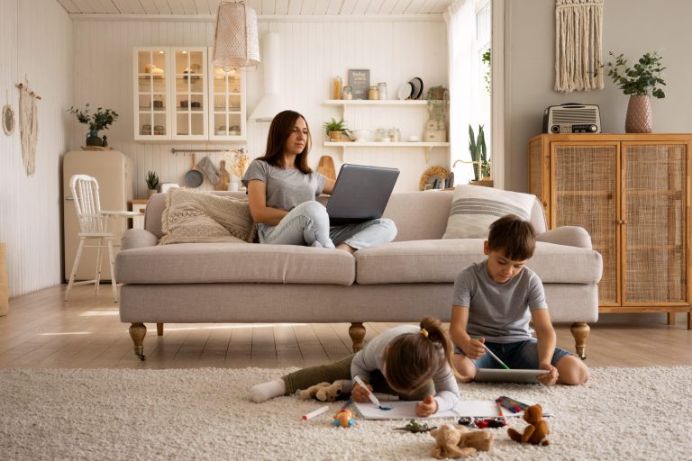 Woman in living room wih kids illustrate blog "Why Is My AC Filter So Dirty?"