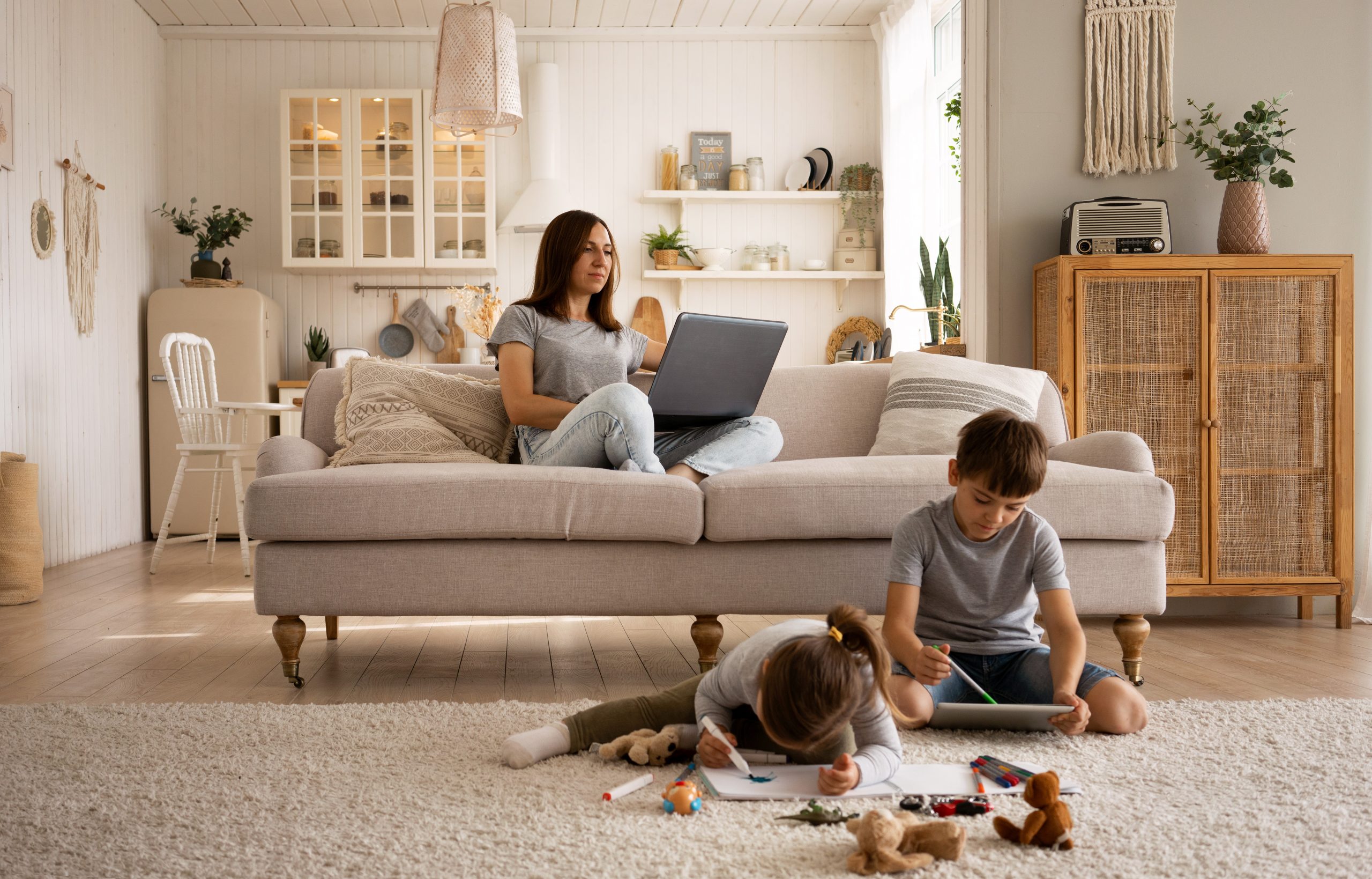 Woman in living room wih kids illustrate blog "Why Is My AC Filter So Dirty?"