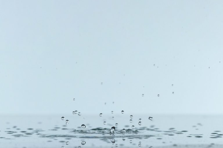 Closeup of drops of water falling.